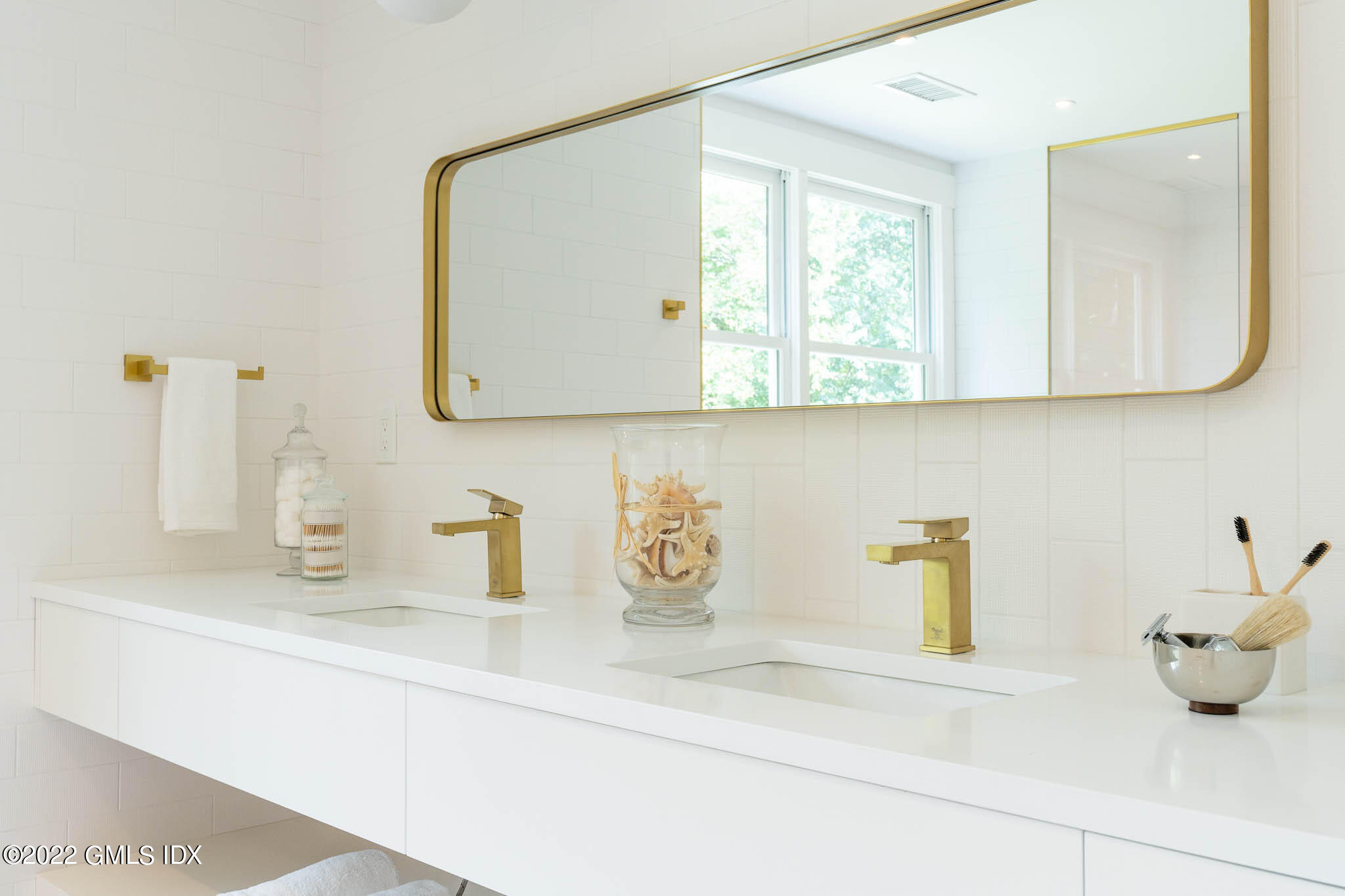 21 Hedgerow Lane Greenwich, CT 06831 - Photo 32 of 35 a bathroom with a sink and a mirror