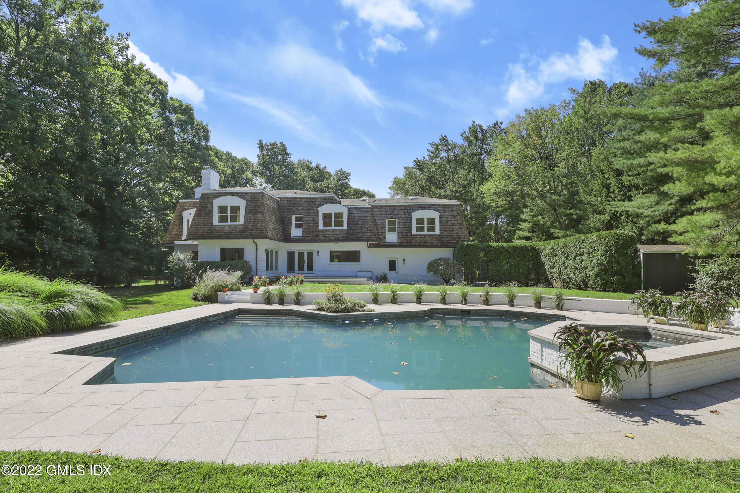 21 Hedgerow Lane Greenwich, CT 06831 - Photo 33 of 35 a view of swimming pool with lawn chairs and plants