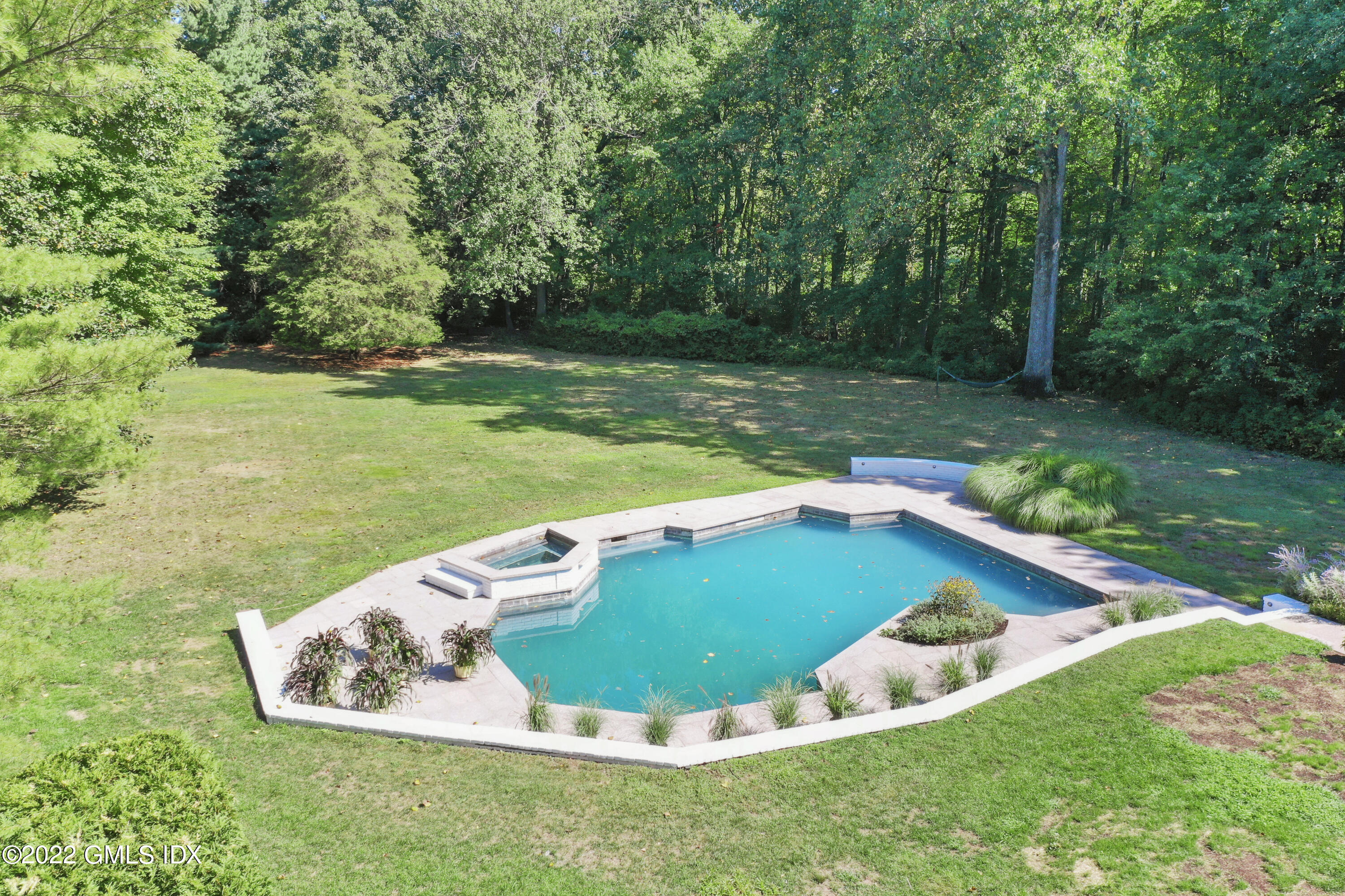 21 Hedgerow Lane Greenwich, CT 06831 - Photo 35 of 35 a view of a back yard with a table and chairs