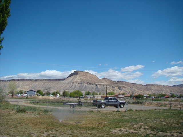 3399 F Road Clifton, CO 81520 - Photo 2 of 17 a view of large green field with mountains in the background