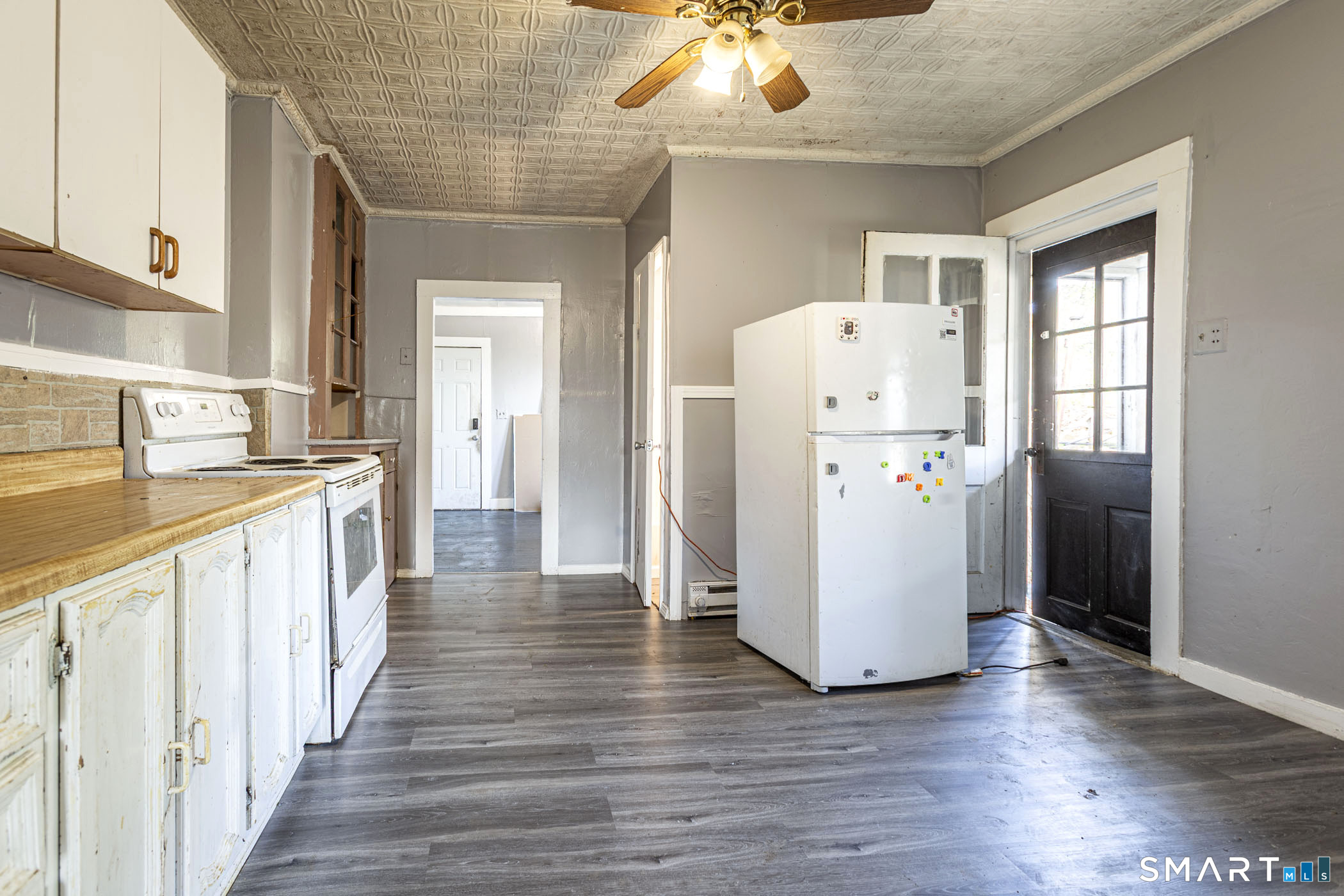 17 Hawthorne Terrace Torrington, CT 06790 - Photo 11 of 37 a view of a kitchen with a refrigerator a kitchen stove top oven and cabinets