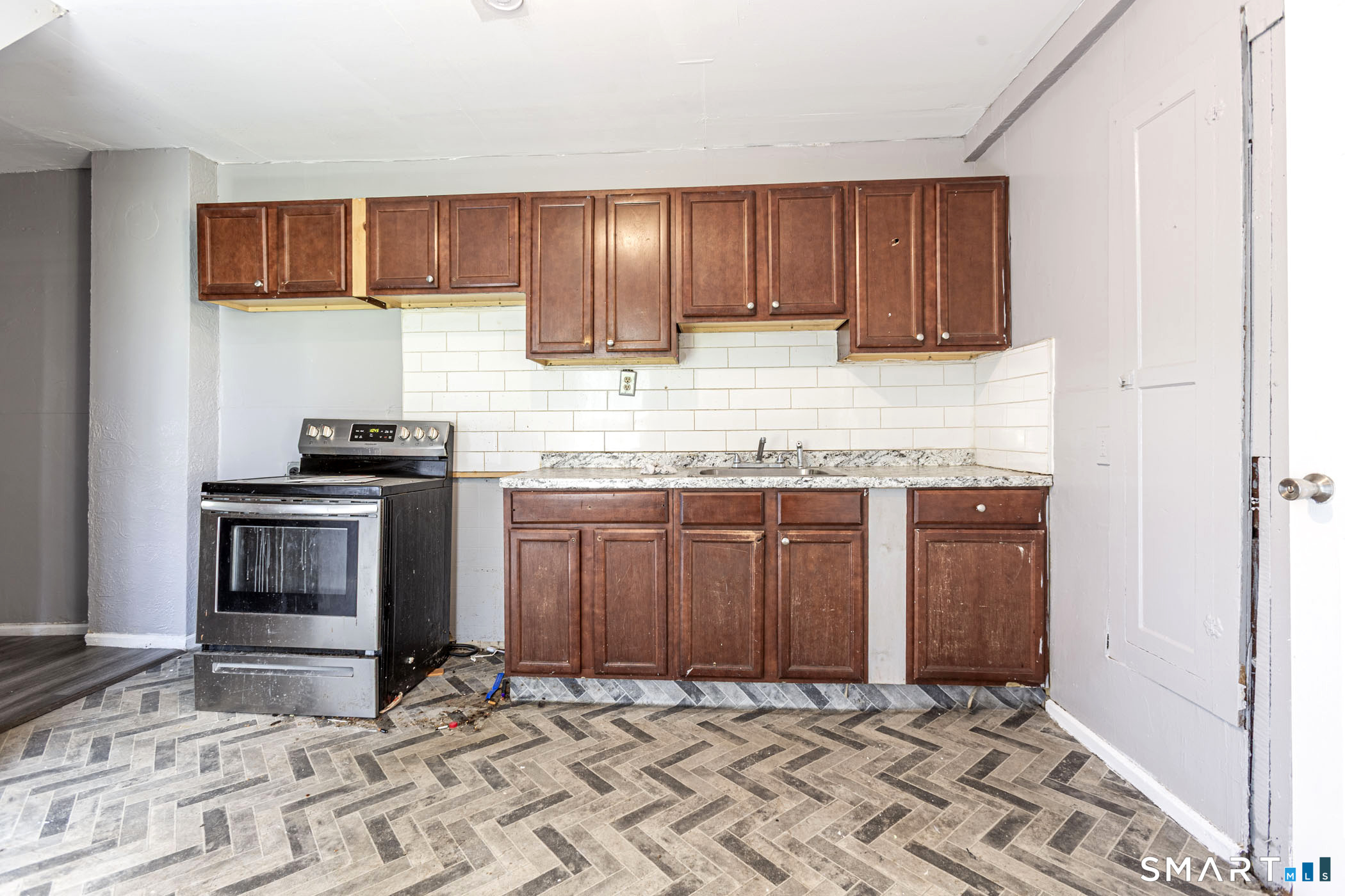 17 Hawthorne Terrace Torrington, CT 06790 - Photo 25 of 37 a kitchen with granite countertop a sink stove and cabinets