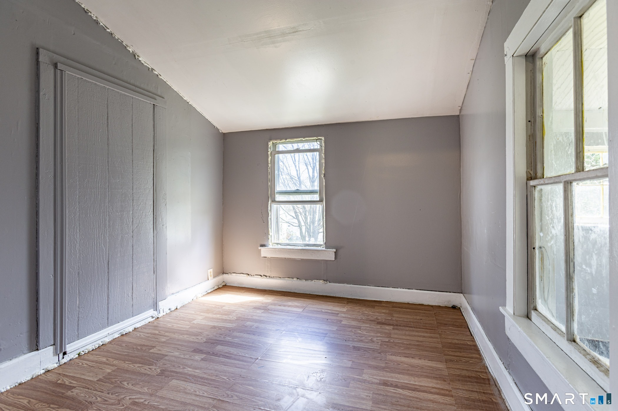 17 Hawthorne Terrace Torrington, CT 06790 - Photo 27 of 37 an empty room with wooden floor and windows