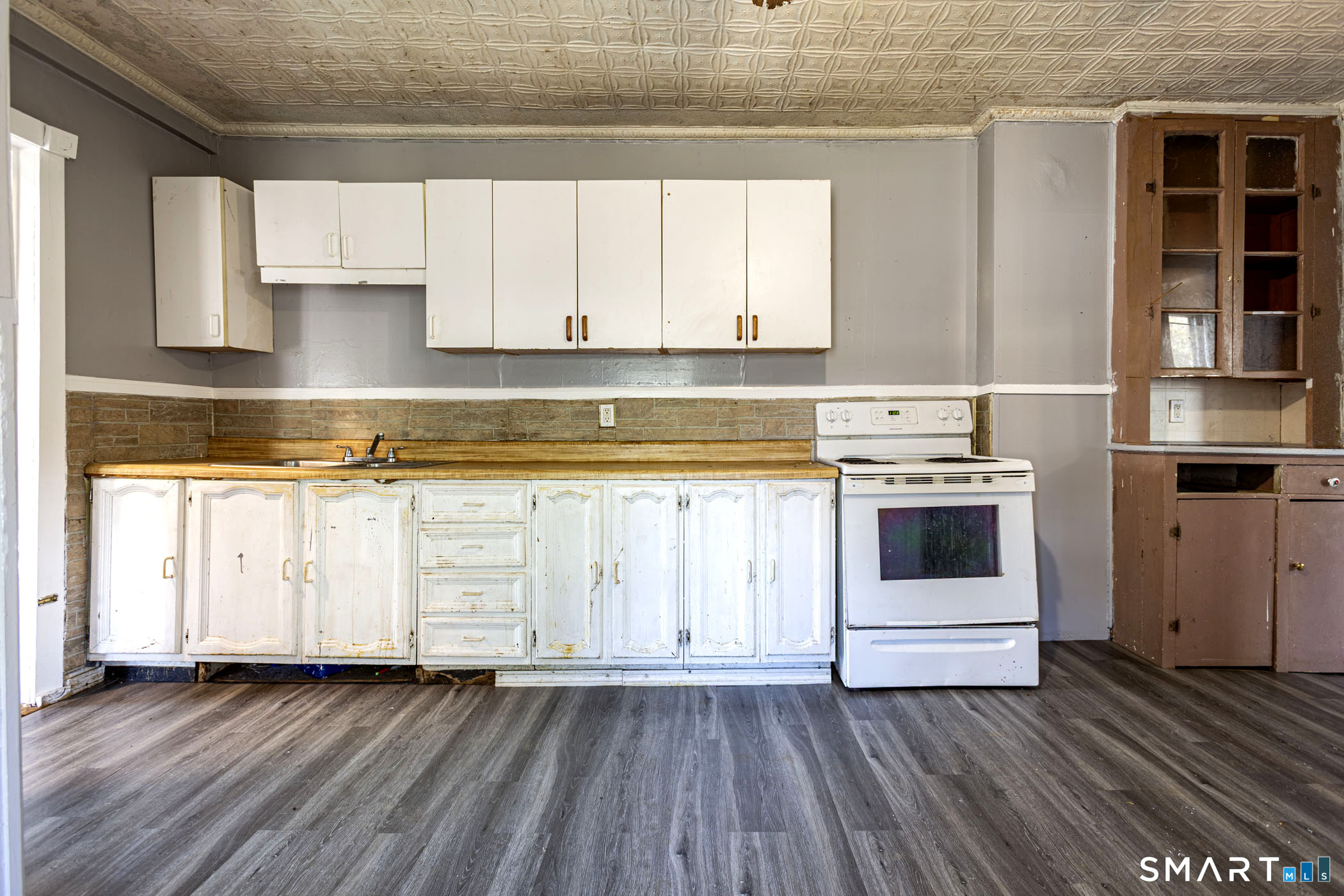 17 Hawthorne Terrace Torrington, CT 06790 - Photo 8 of 37 a white kitchen with wooden floors and white stainless steel appliances