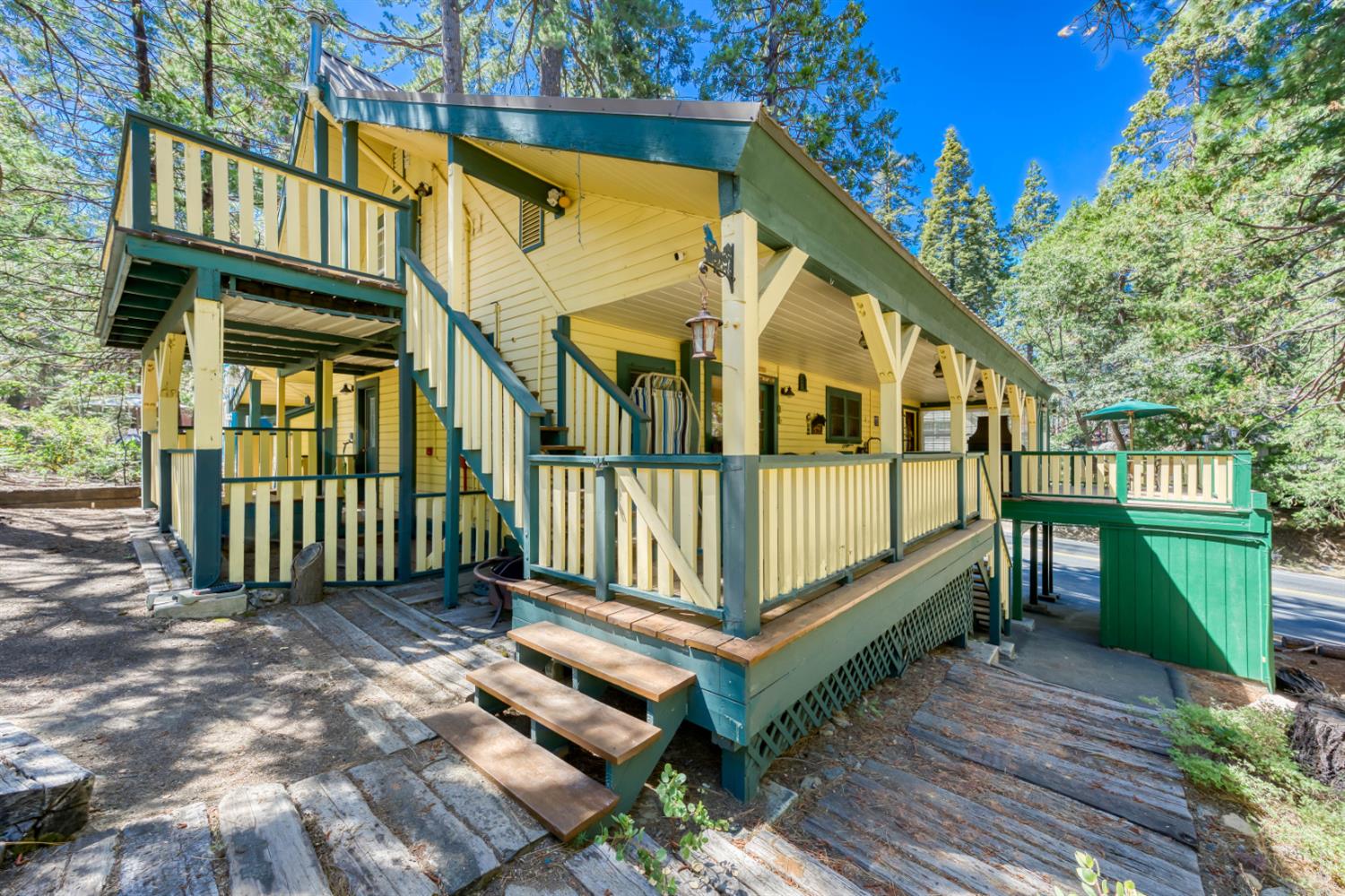 42025 Tollhouse Road Shaver Lake, CA 93664 - Photo 7 of 64 a view of a house with a small yard and wooden fence