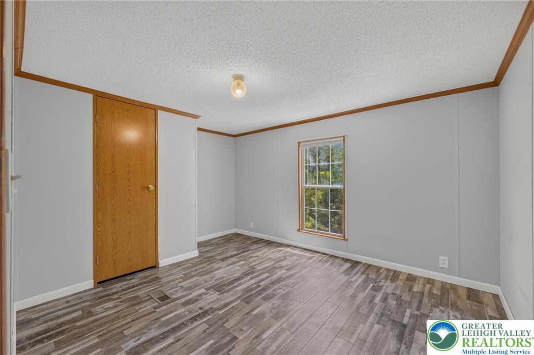 2674 Williams Road Danielsville, PA 18038 - Photo 27 of 31 A versatile space features modern laminate flooring and a bright window, offering a refreshing view.