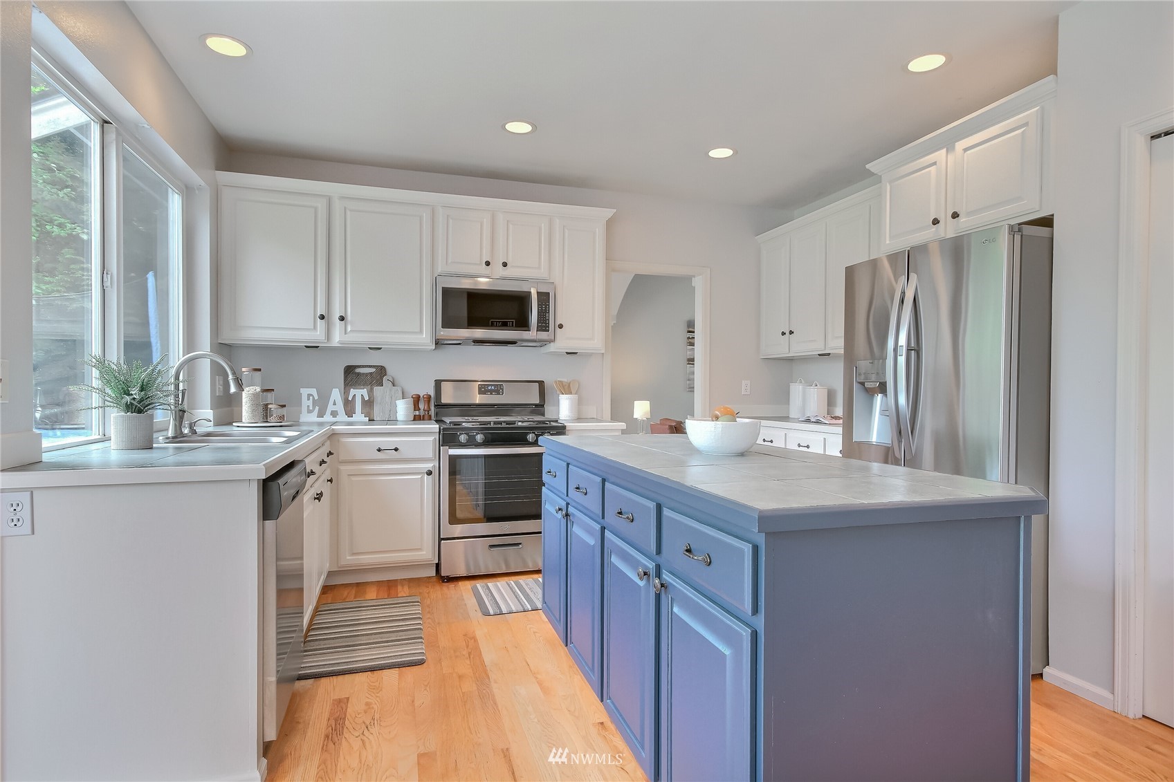 3007 204th Street Southeast Bothell, WA 98012 - Photo 17 of 37 a kitchen with stainless steel appliances granite countertop a refrigerator stove microwave and sink