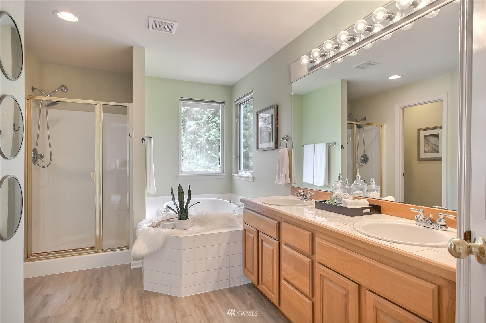 3007 204th Street Southeast Bothell, WA 98012 - Photo 24 of 37 a bathroom with a double vanity sink a mirror and shower