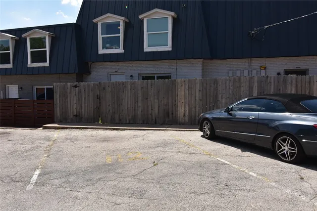 a view of a car parking in front of a house
