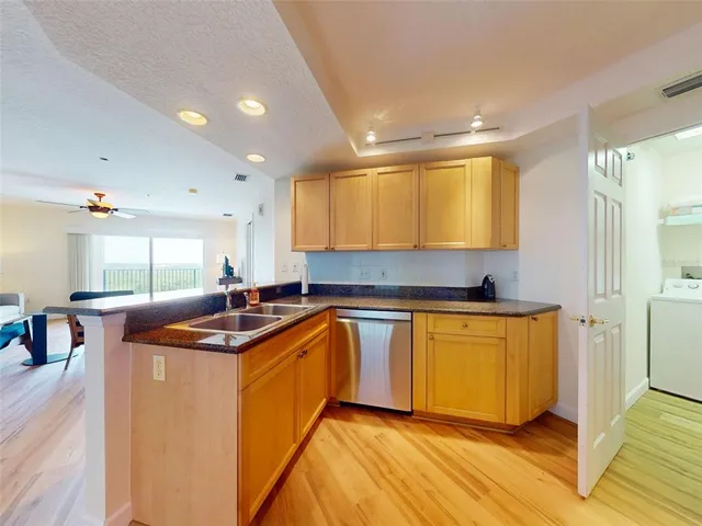 a kitchen with stainless steel appliances granite countertop a sink and cabinets