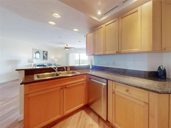 a kitchen with granite countertop a sink and cabinets