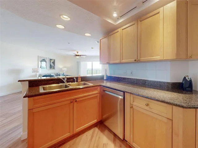 a kitchen with granite countertop a sink and cabinets