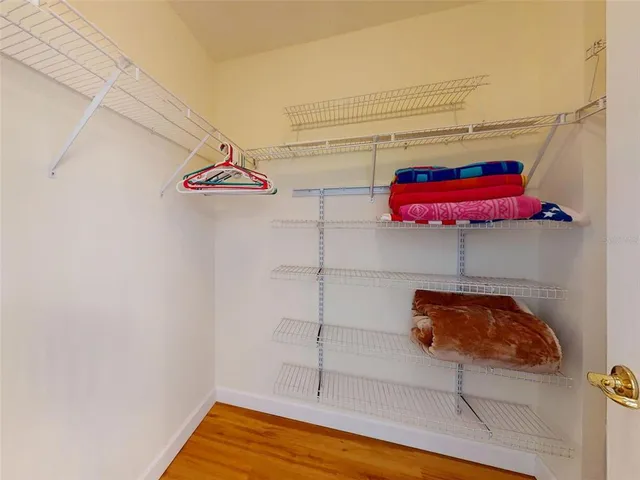 a spacious bathroom with a granite countertop sink mirror and bathtub