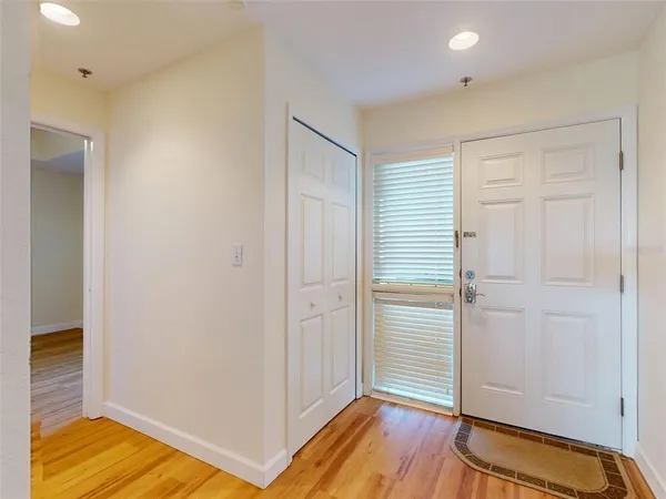 a view of room with walk in closet and wooden floor