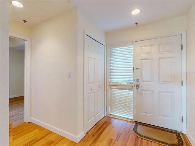 a view of room with walk in closet and wooden floor