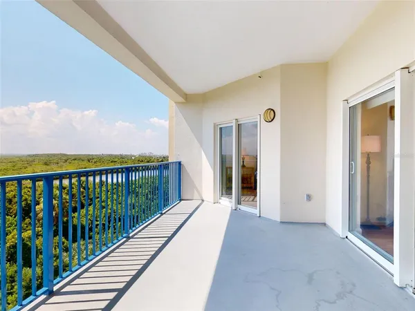 a kitchen with stainless steel appliances granite countertop a dining table chairs refrigerator and sink