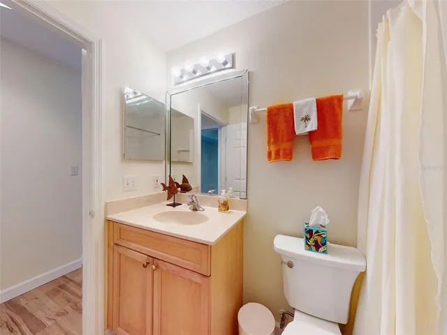 a bathroom with a sink mirror vanity and toilet