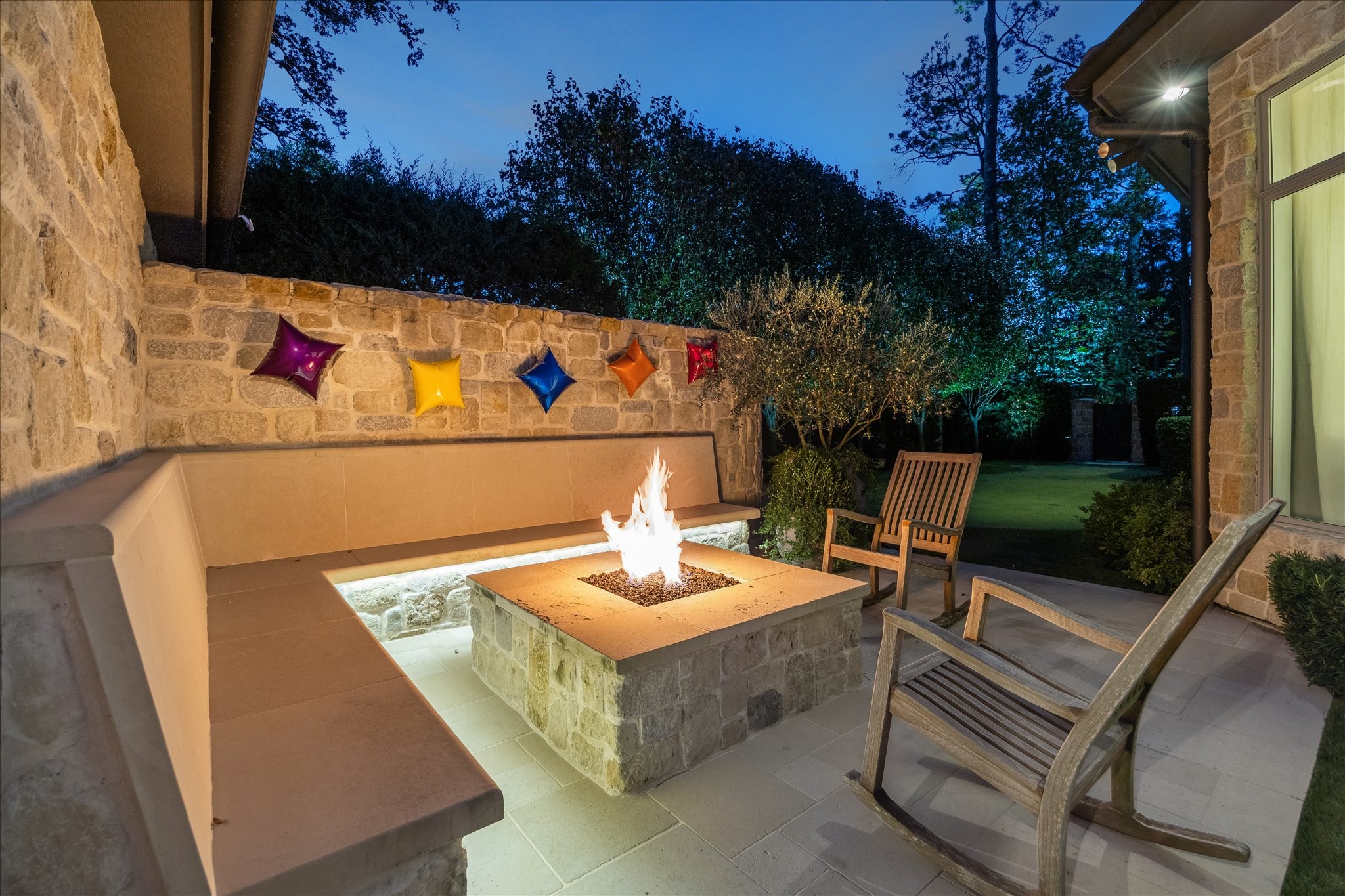 220 Merrie Way Lane Houston, TX 77024 - Photo 50 of 50 A custom firepit surrounded by built-in seating creates a warm, inviting spot for relaxed evenings outdoors.