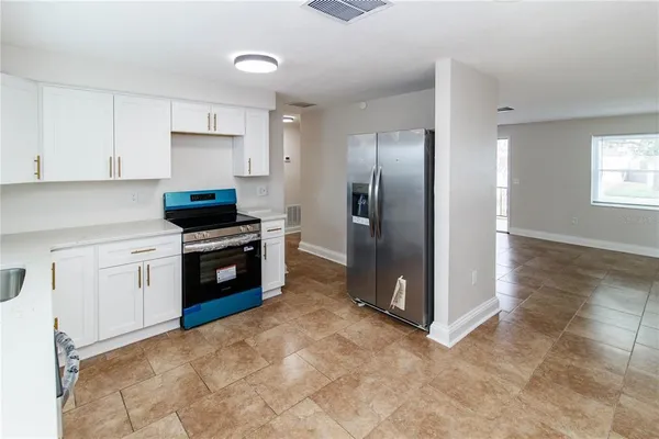 a kitchen with stainless steel appliances a refrigerator sink and stove