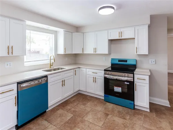 a kitchen with a stove sink and window