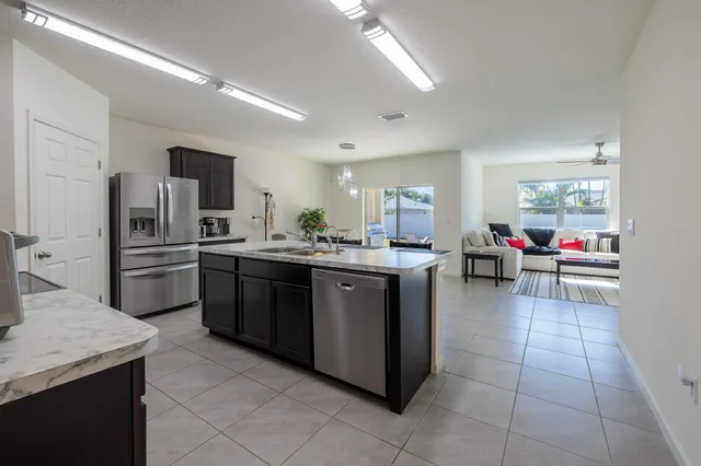 a kitchen with a sink appliances and cabinets