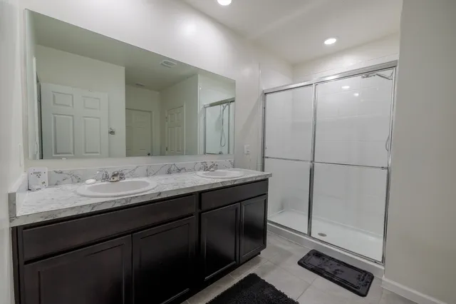 a bathroom with a double vanity sink a and mirror