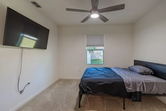 a bedroom with a bed and a chandelier