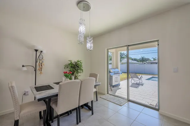 a view of a dining room with furniture and chandelier