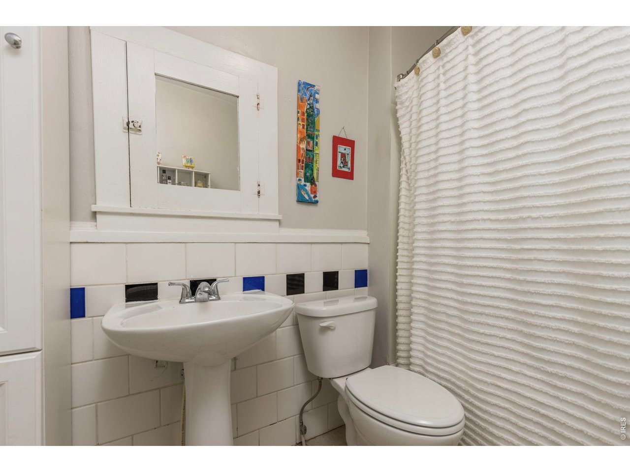 206 South Shields Street Fort Collins, CO 80521 - Photo 12 of 47 a bathroom with a toilet a sink and mirror