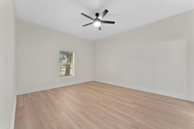 wooden floor in an empty room with a window