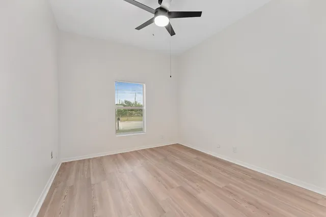 wooden floor in an empty room with a window
