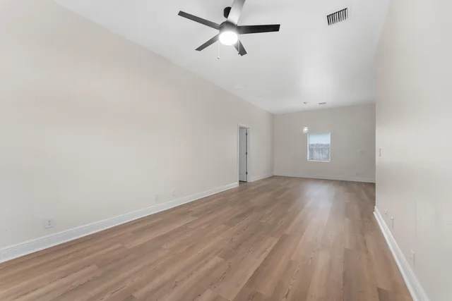 wooden floor in an empty room with a window