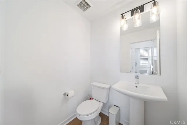 a white toilet sitting next to a bathroom sink