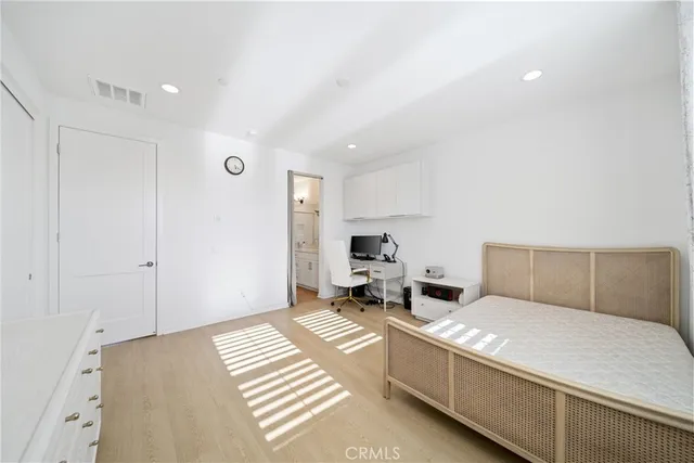 a bed room with a bed and a chair