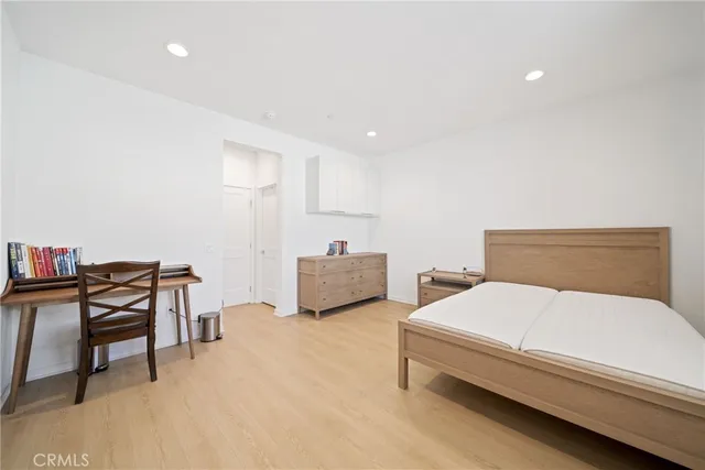 a bedroom with a bed and a chair