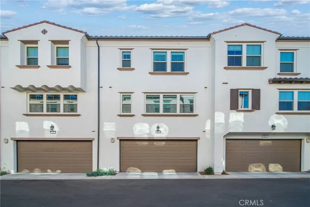 a front view of a house with a parking area