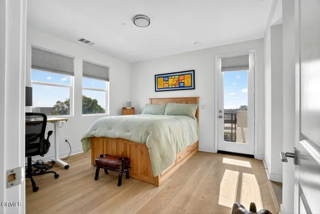 a bedroom with a bed and a large window