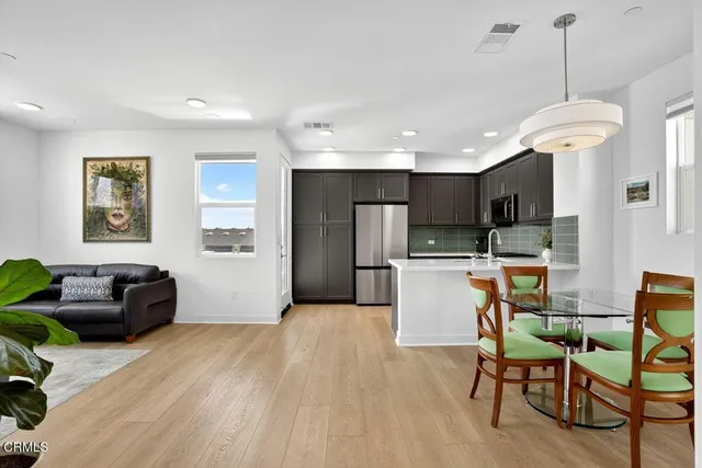 a view of a kitchen with furniture and wooden floor