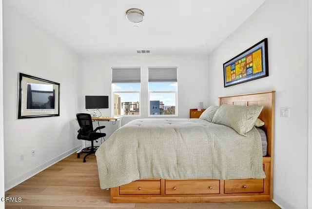 a bedroom with a bed and a desk