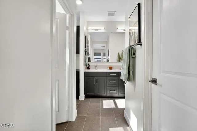a bathroom with a sink a mirror and a shower
