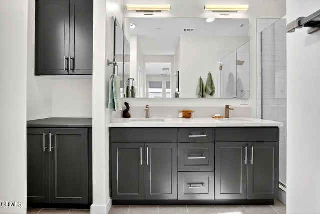 a bathroom with a sink double vanity and a mirror