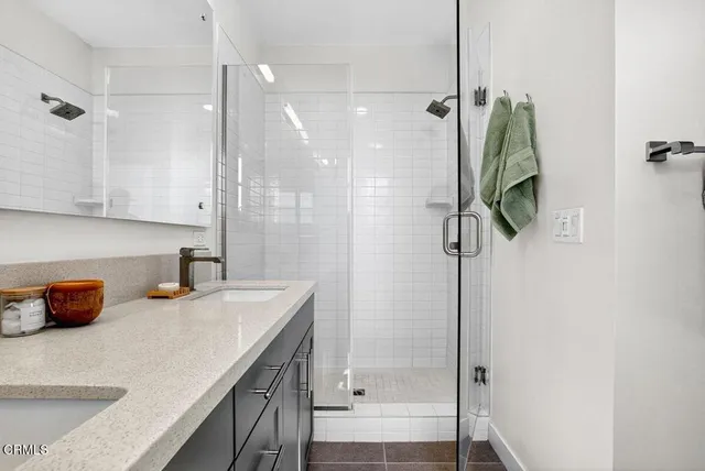 a bathroom with a sink and shower