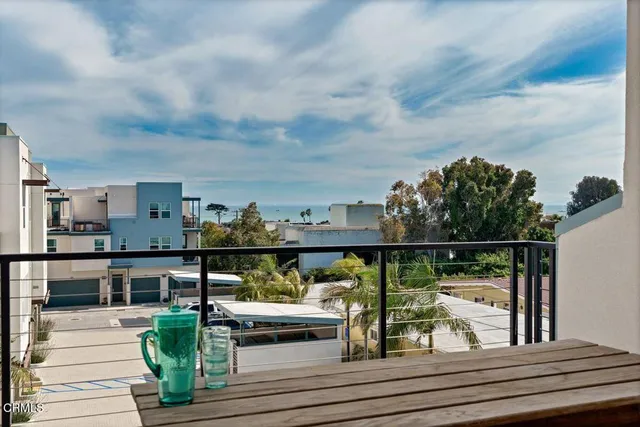 a view of a balcony with wooden floor and outdoor seating