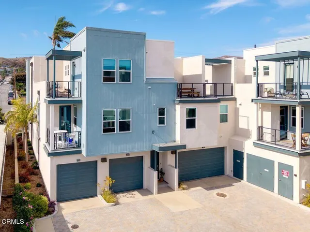 a view of kitchen with stainless steel appliances granite countertop a stove and a sink