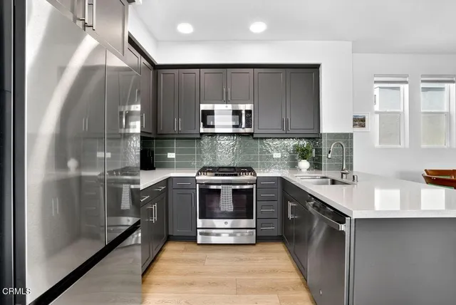 a kitchen with a sink cabinets and stainless steel appliances