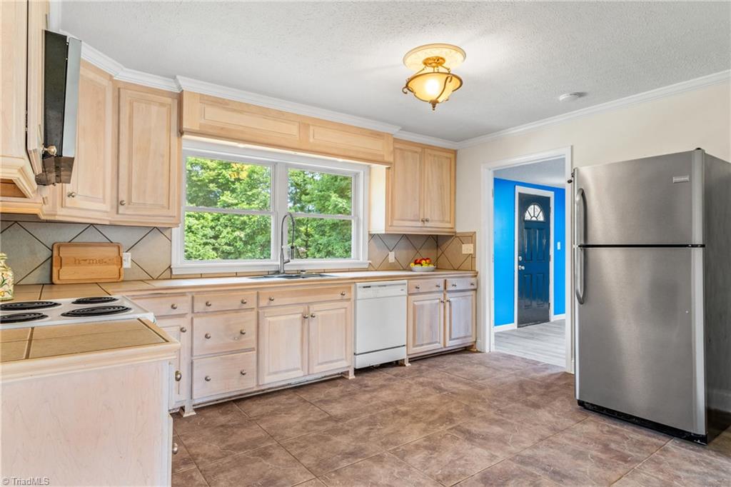 753 Wolf Island Road Reidsville, NC 27320 - Photo 11 of 42 Prior owner installed custom birch cabinets in kitchen remodel