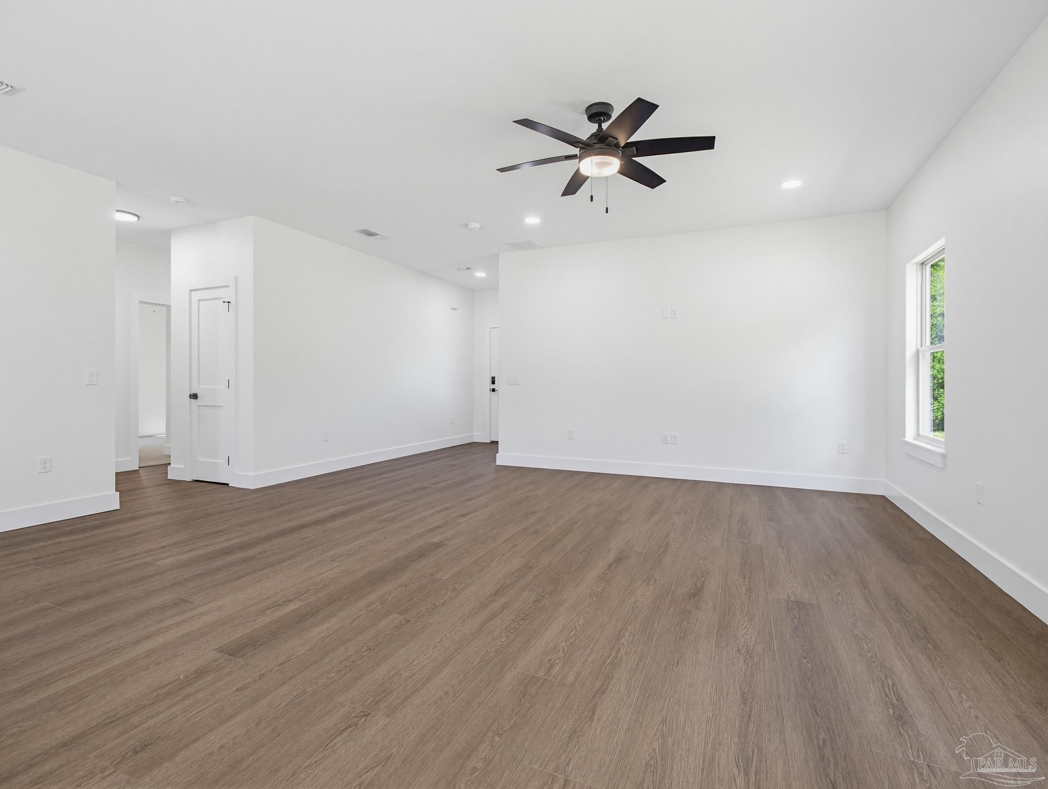 5724 Riviera Drive Milton, FL 32583 - Photo 12 of 52 wooden floor in an empty room with a window