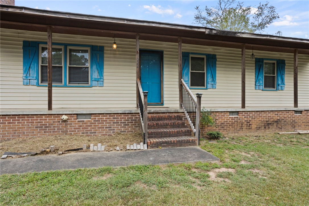 1022 Lakemont Road Starr, SC 29684 - Photo 5 of 24 A welcoming front porch with classic columns and brick steps leads to the entry.