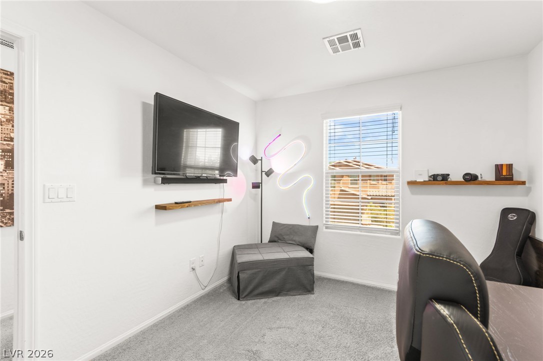 6435 Point Isabel Way Las Vegas, NV 89122 - Photo 39 of 57 A versatile secondary room offers soft carpeting, a window for natural illumination, and crisp white walls.