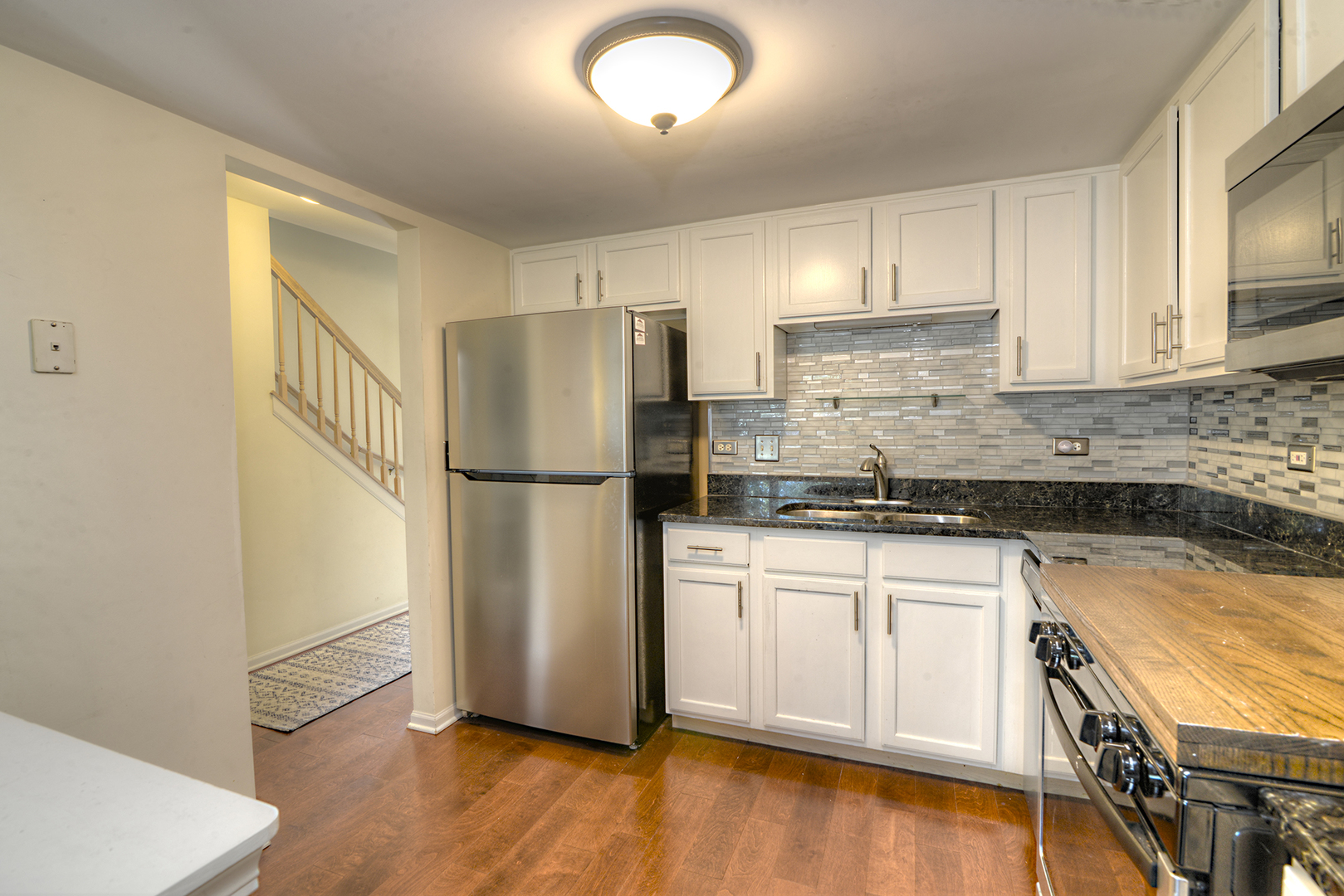 1063 Horizon Ridge Lake In The Hills, IL 60156 - Photo 9 of 27 a kitchen with granite countertop a refrigerator sink and cabinets